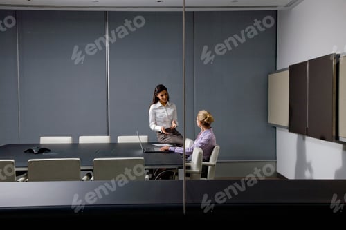 Preview: A Wide View Of Businesswomen Talking With Each Other While Working On A Project In A Conference Room