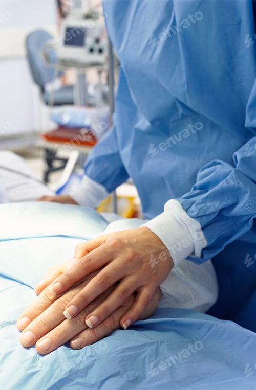 Preview: A Vertical Close Up Of Surgeon In Surgical Suit Touching Patient?S Hand For Expressing Love And Care