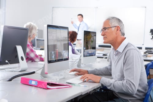 Preview: A Medium Shot Of A Senior Man With Gray Hair Working Seriously On A Computer In A Lab With Teacher