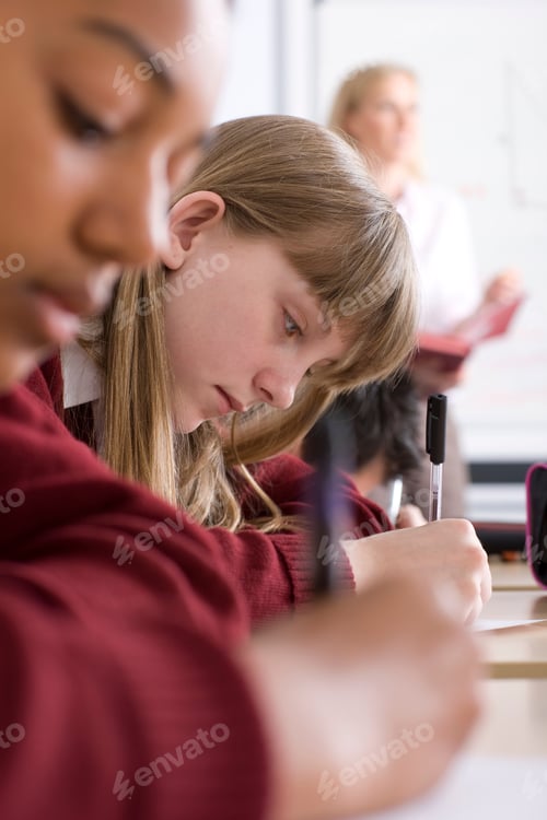 Preview: A Vertical Sideview Of Students Sitting In A Row With Selective Focus Taking A Test In An Exam Hall