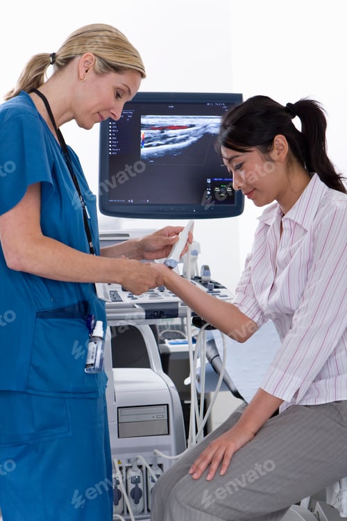 Preview: A Vertical Side View Of A Qualified Technician Wearing A Blue Scrub Suit Using Ultrasound Treatment