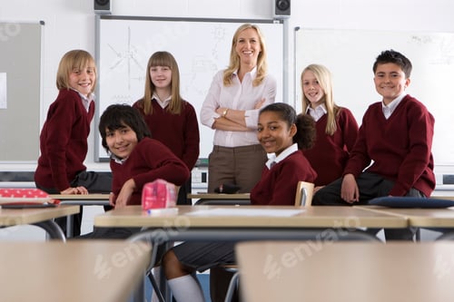 Preview: Happy Students And A Proud Teacher Posing And Standing With Her Arms Crossed In Classroom On The