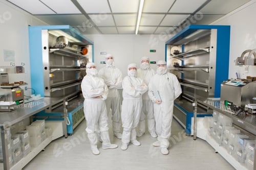 Preview: A Portrait Of Scientists In Clean Suits Standing Together In A Silicon Wafer Manufacturing
