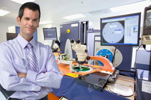 Preview: A Portrait Of A Smiling Businessman Standing With His Arms Crossed In A Silicon Wafer Manufacturing