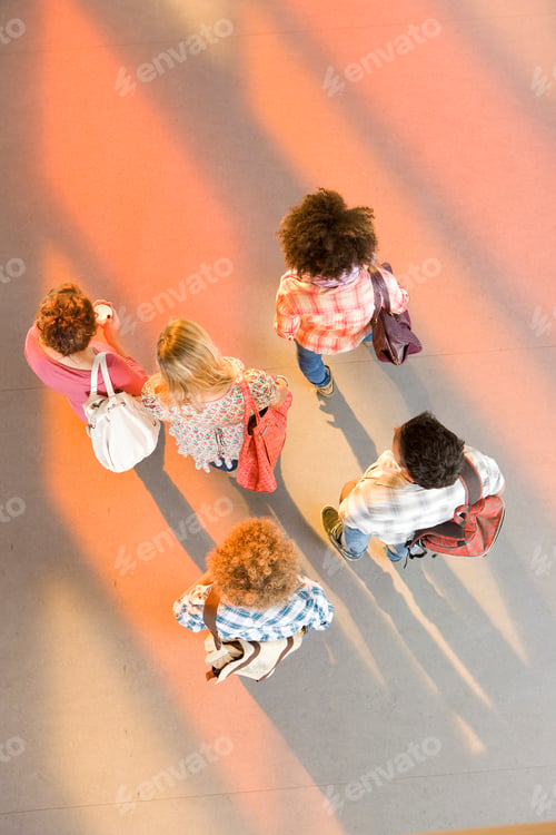 Preview: A Top Angle Vertical Shot Of Young Students Walking Together In A School Corridor With Their