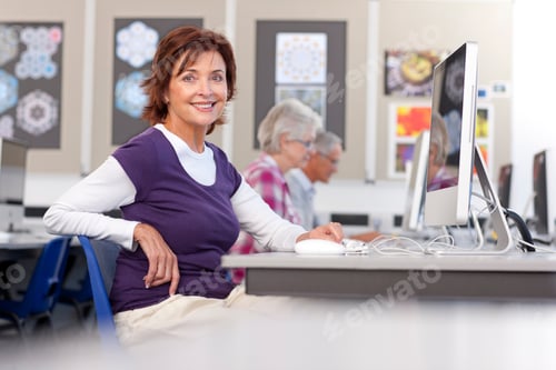 Preview: A Medium Shot Of A Senior Woman Smiling At Camera In A Computer Lab.