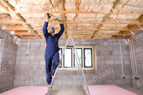 Preview: A Wide Shot Of A Man In Coveralls Wearing Protective Mask Standing On A Ladder And Installing