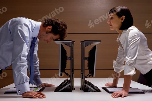 Preview: A Side Profile Shot Of A Businesswoman Watching A Frustrated Businessman Leaning His Head On A