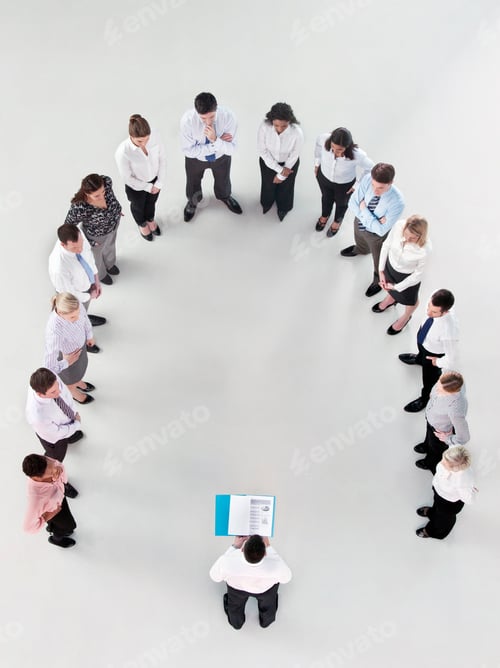 Preview: Overhead Shot Of A Group Of Businesspeople Standing In A Horseshoe Formation Listening To A