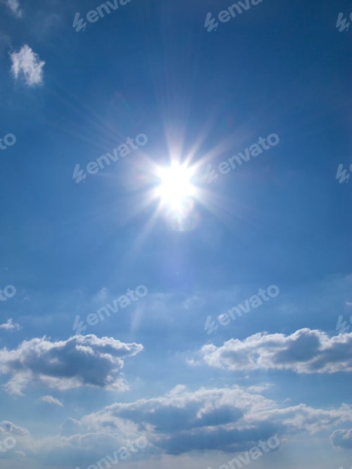 Preview: A Vertical View Of Glowing Sun In A Blue Summer Sky With Nice White Floating Clouds.