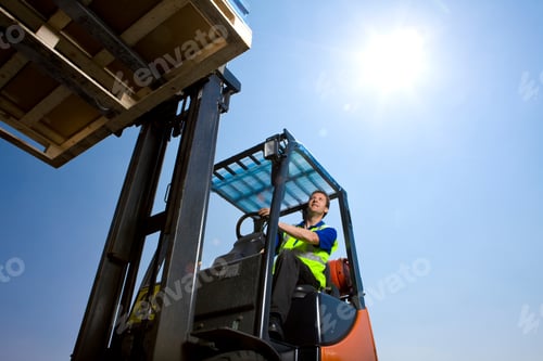 Preview: A Low Angle Shot Of A Worker In Safety Vest Using Forklift To Move The Merchandise At Loading Dock