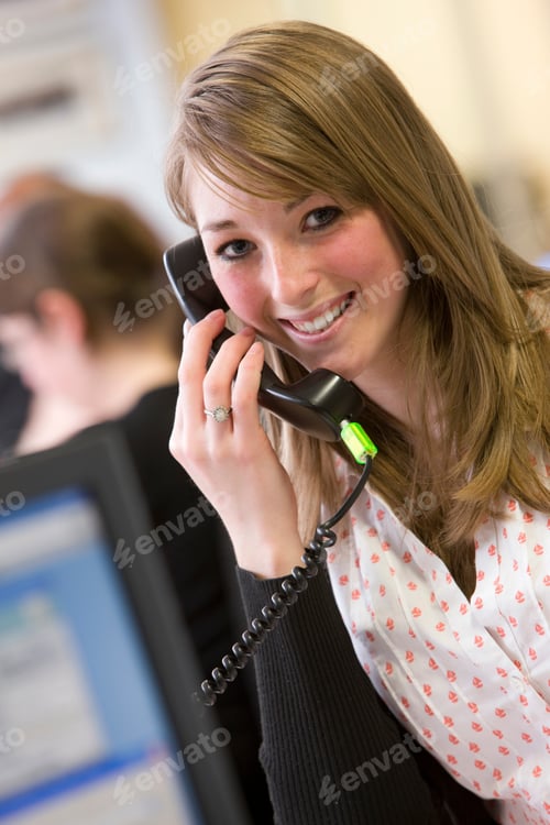 Preview: A Close Up Portrait Shot Of A Young Smiling Businesswoman Talking On A Telephone.