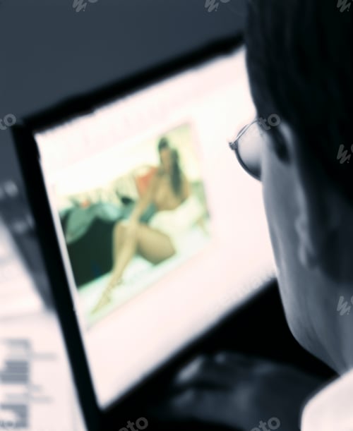 Preview: A Blurry Close Up Vertical Shot Of A Businessman Watching Porn On An Office Computer.