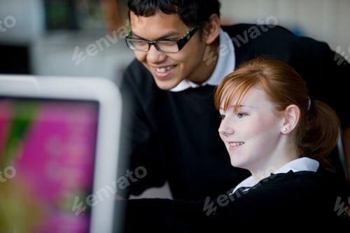 Preview: A Closeup Of Smiling Teenagers Using A Computer For Their Project In School?S It Lab
