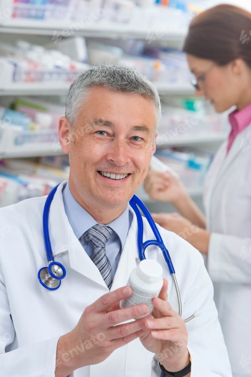 Preview: A Portrait Shot Of A Smiling Pharmacist With A Stethoscope Around His Neck Looking At The Camera