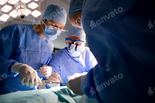 Preview: A Group Of Skilled Surgeons Attentively Performing A Serious Operation In The Operating Room