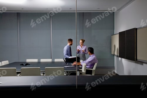 Preview: A Wide View Of A Small Group Of Business People Talking With Each Other In The Conference Room