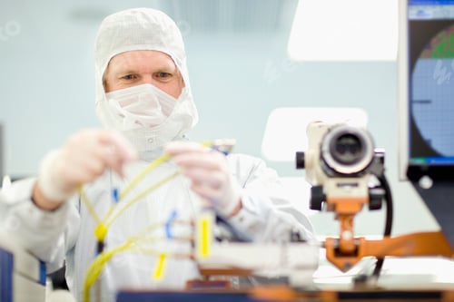 Preview: A Scientist In Clean Suit Adjusting Wires On The Machine In A Silicon Wafer Manufacturing