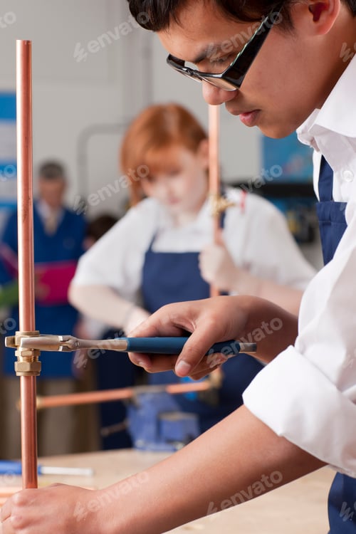 Preview: A Side Profile Vertical Shot Of A Young Boy With Glasses Using Wrench To Tighten Valve On A Cooper
