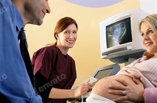 Preview: A Qualified Nurse Performing An Ultrasound Examination On A Pregnant Woman Smiling At Her Husband