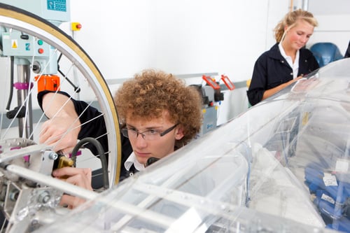 Preview: A Close Up Shot Of A Young Boy Working On A Electric Vehicle Prototype In A Vocational School.