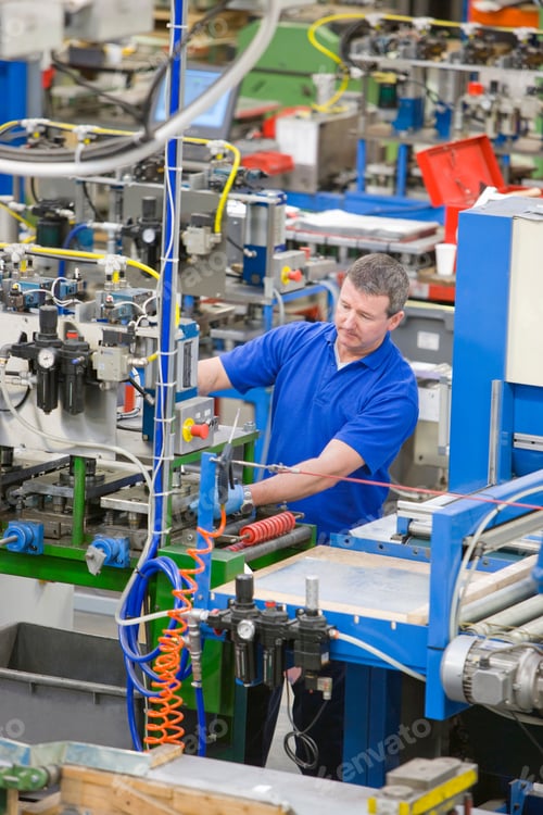 Preview: A Portrait Shot Of A Worker Operating Machinery On A Production Line In An Aluminum Light Fittings