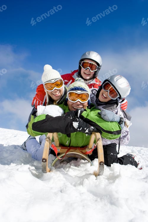 Preview: Entire Family Lying On The Sled While Sledding Down A Ski Slope On Top Of A Remote Mountain