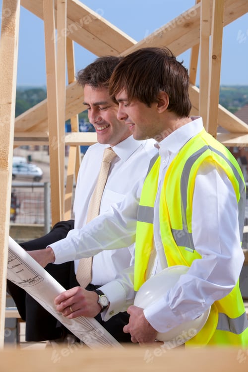 Preview: A Vertical Side View Of An Architect And An Engineer Reviewing Blueprints At The Construction Site