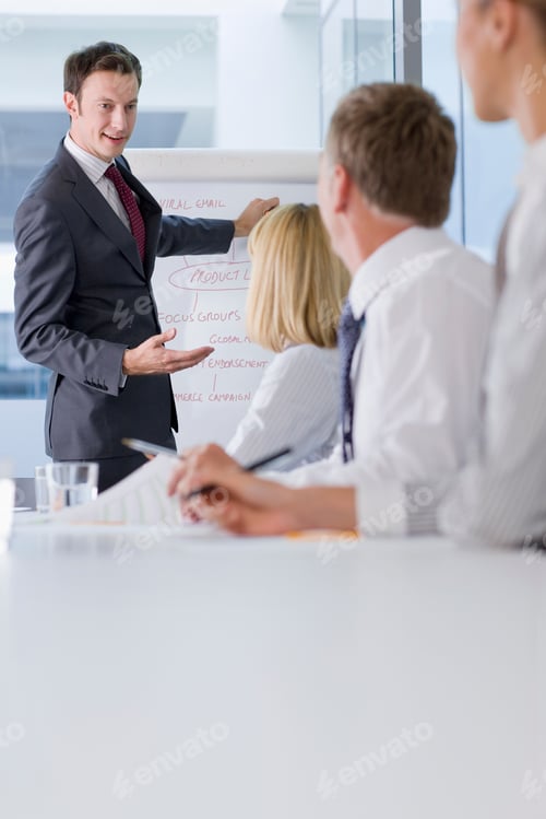 Preview: A Horizontal View Of A Smiling Businessman Speaking To His Co-Workers During A Meeting In The