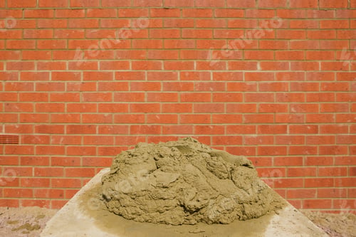 Preview: A Heap Of Cement For Bricklaying Placed In Front Of A Brick Wall
