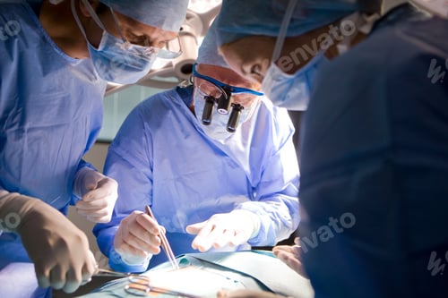 Preview: A Team Of Skilled Surgeons Cautiously Performing An Operation In The Operation Theatre