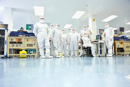 Preview: A Low Angle Group Portrait Of Engineers Wearing Clean Suits In A Silicon Wafer Manufacturing