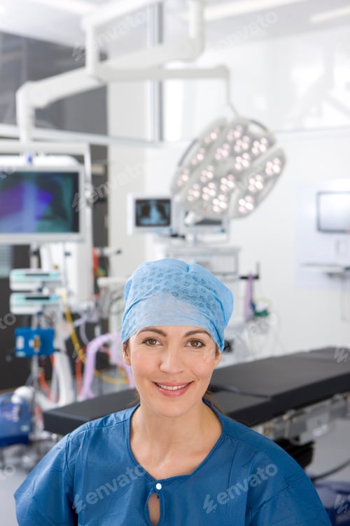Preview: A High Angle Shot Of A Smiling Lady Surgeon On A Background Of An Operation Theatre Wearing A Scrub
