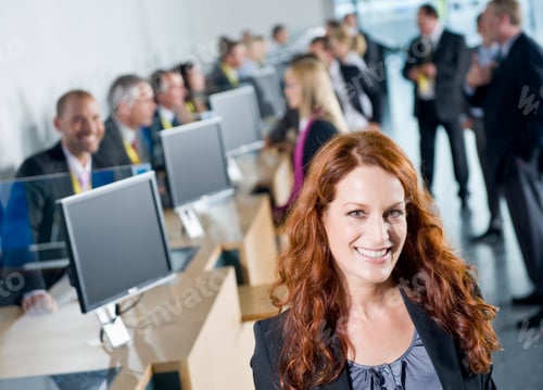Preview: A Wide View Of A Slant Frame With A Confident Businesswoman Standing In The Foreground Over A Busy