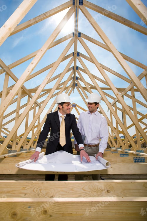 Preview: Two Smiling Architects Standing In The Middle Of Construction Frames While Discussing And Reviewing
