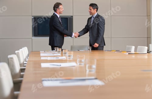 Preview: Two Smart Businessmen In Formal Suits Shaking Hands With Each Other In A Conference Room