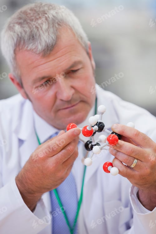 Preview: Vertical Head And Shoulder Shot Of A Chemical Engineer Examining A Molecular Structure.
