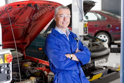 Preview: A Qualified Teacher In Blue Uniform Leaning Against An Open Hood Car With His Arms Crossed While
