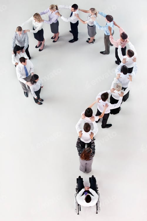 Preview: Overhead Shot Of A Businessman In A Wheelchair At The End Of A Question Mark Formed By Standing