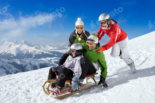 Preview: Family Enjoying In The Snow With Father And Son Being Pushed Downhill Through The Snowy Slope While