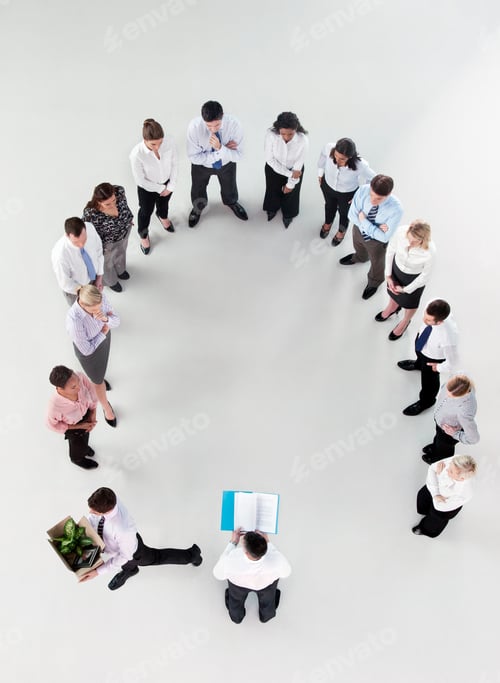 Preview: Overhead Shot Of A Group Of Businesspeople Standing In A Horseshoe Formation Listening To A