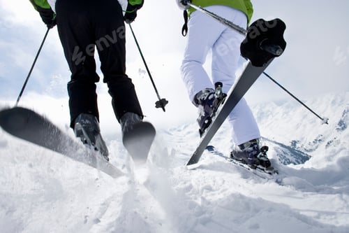 Preview: A Cropped Shot Of The Feet Of Two Skiers In The Snow On A Mountain Top As They Are About To Ski