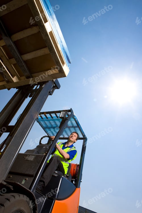 Preview: A Slanted Low Angle Vertical Shot Of A Worker In Safety Vest Using Forklift To Move The Merchandise