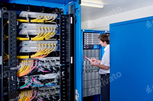 Preview: Wide Shot Of An It Technician Holding Pen And Paper Examining Lan Network In Selective Focus Inside