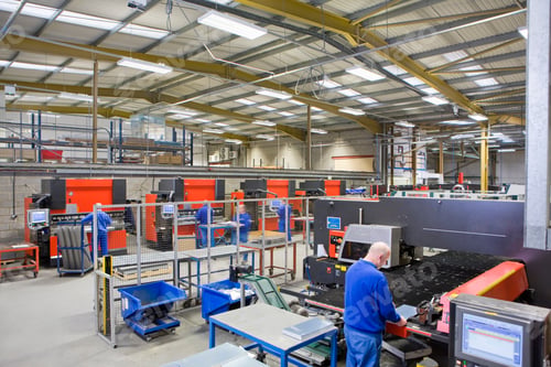 Preview: A High Angle Wide Shot Of A Senior Worker Inspecting Aluminum Light Fitting At Machinery In A