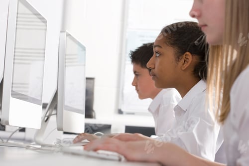 Preview: Serious Students In Computer Class Sitting In A Row�Learning And Working On Desktop Computers�