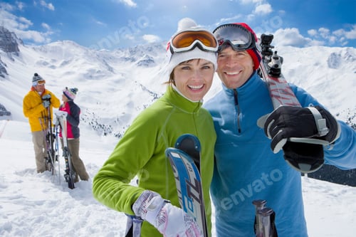 Preview: Friends Hanging Out On A Snowy Mountain Carrying Skis While Smiling At The Camera