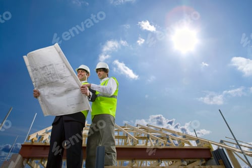 Preview: A Low Angle View Of Two Professional Architects Wearing Helmet And A Safety Vest At A Construction