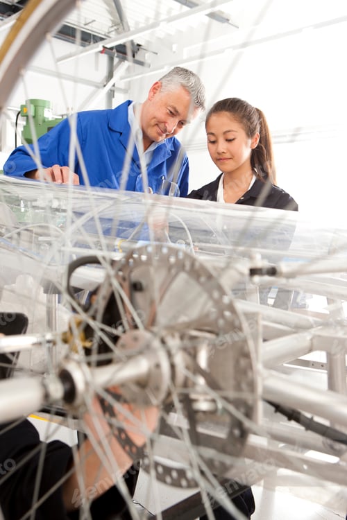 Preview: A Portrait Shot Of A Teacher Helping A Young Girl In Constructing An Electric Vehicle Prototype