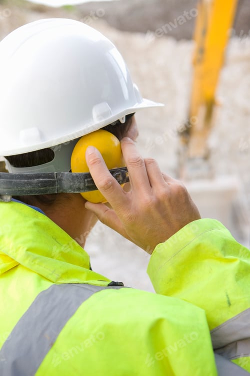 Preview: A Close Up Portrait Shot Of A Construction Worker Touching His Ear Protectors From Backside.